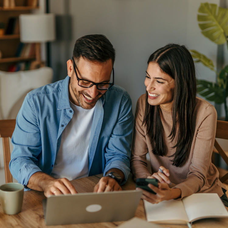 Father and daughter, looking at a tablet at ways to save on their heating costs.