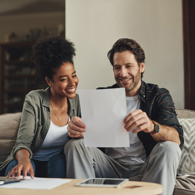 Father and daughter, looking at a tablet at ways to save on their heating costs.